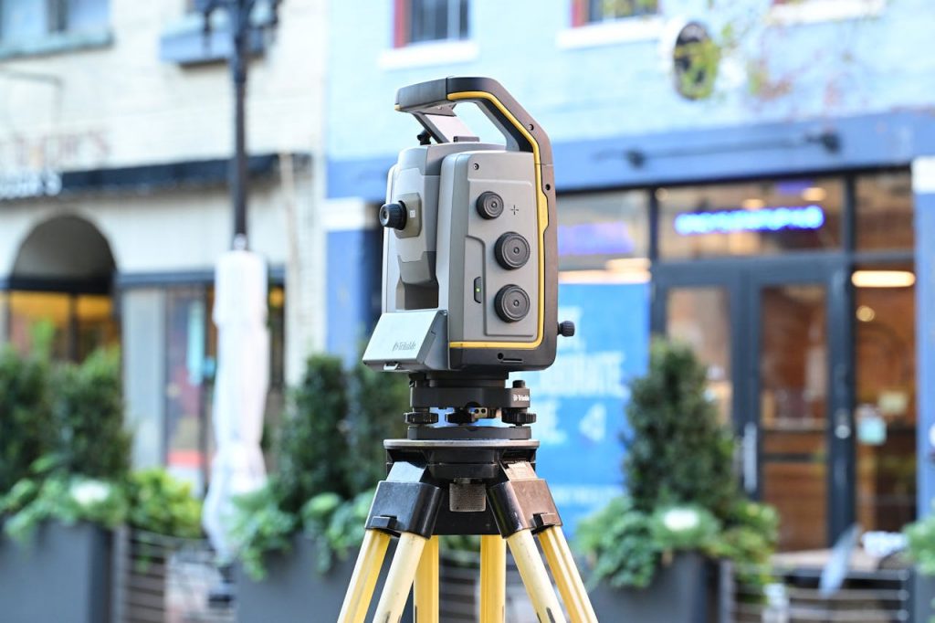 pexels-photo-29356756 Sophisticated surveying equipment on city street showcasing modern urban mapping technology.